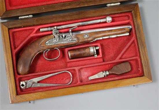 A Portuguese novelty 925 white metal mounted walnut model of a flintlock pistol with accessories, cased.